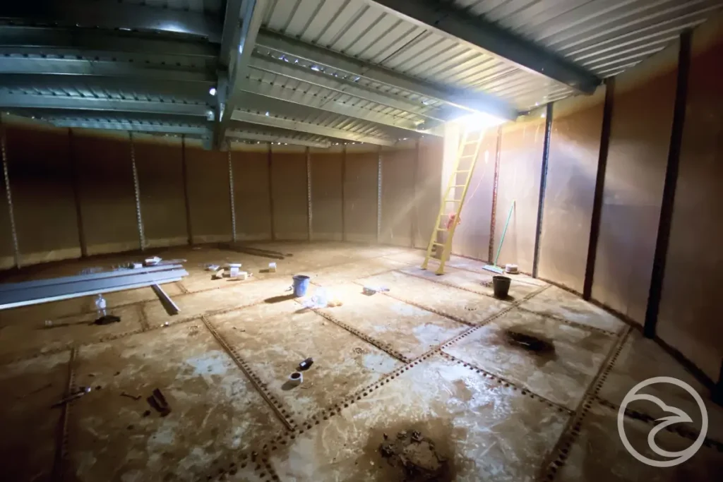 Professional tank refurbishment team repairing rural farm tank